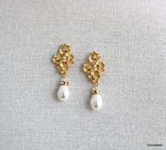 These elegant pearl earrings have small flower pendants in gold plated finish and Austrian teardrop pearls.   Pearls measure 11 x 8 mm. Earrings are approximately 1 1/2" long from top to bottom by 1/2" wide.   Each flower has a tiny clear cubic zirconia in the center.  Post is .925 sterling silver over brass.   Please choose desired pearl color and finish at checkout.  Perfect for any nature inspired bride! Matching necklace, https://www.etsy.com/listing/274801382/backdrop-pearl-necklacecrystal? Gold Pearl Flower Earrings For Wedding, Elegant Gold Pear-shaped Bridal Earrings, Delicate Gold Pearl Chandelier Earrings, Gold Pearl Chandelier Earrings Delicate Style, Gold Pearl Chandelier Earrings In Delicate Style, Gold Teardrop Pearl Earrings With Pearl Charm, Gold Teardrop Earrings With Pearl Charm, Gold Pearl Teardrop Dangle Earrings, Gold Pearl Teardrop Earrings With Pearl Drop