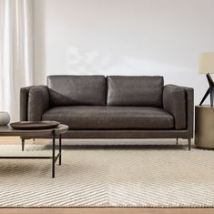 a living room scene with focus on the couch and coffee table in the foreground