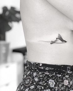 a woman with a small tattoo on her stomach