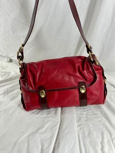 "Measurements are 15\" wide, 9\" high, 5\"5  deep with one 37\" shoulder strap at its longest with a 17\" drop. There is one  inner compartment lined in colorful signature fabric, back zipper pocket, front closures along with a front zipper pocket under flap.  This  genuine Marino Orlandi  leather shoulder bag is made of two tone red leather, gold tone hardware and one back zipper pocket for easy to access items. There are a few very light scuffs on leather along with a light ink mark on the bottom with no tears or holes.  Made in Italy by Marino Orlandi. ----------------------------------------I SHIP WORLDWIDE------------------------------------------------- I want to stress that item is vintage which means it's not new. All my customers are very important to me and I believe communicatio Red Leather-lined Satchel For Travel, Vintage Hobo Bag With Gold-tone Hardware, Classic Red Shoulder Bag For Travel, Vintage Baguette Bag With Removable Pouch For Travel, Vintage Red Shoulder Bag For Travel, Burgundy Evening Shoulder Bag With Leather Lining, Evening Burgundy Shoulder Bag With Leather Lining, Vintage Leather Baguette Shoulder Bag, Vintage Leather Baguette Bag With Detachable Strap