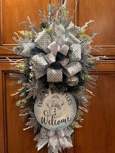 a welcome wreath hanging on the front door