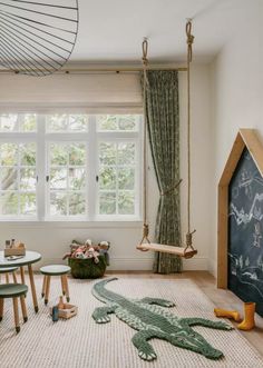 a child's playroom with toys and furniture in the room, including an alligator rug