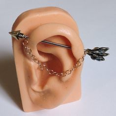 a fake ear with some piercings attached to it