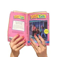 a girl talk book being held up by two hands