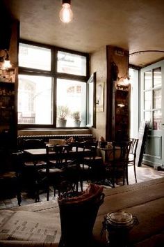 a dimly lit restaurant with tables and chairs