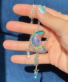 "Celestial Magic to wear around your neck! Featuring vibrant Aurora Opal/Glass Doublets in two shapes; Rainbow Crescent Moon Rainbow Cloud Sterling Silver Charms \"Magical\" hand stamped on back Hand wire wrapped Aura Quartz Rain Drops Sturdy Sterling Silver Oval Cable chain with 20, 18, and 16 inch adjustments Lobster claw clasp closure ⚡️⚡️⚡️⚡️⚡️⚡️⚡️⚡️⚡️⚡️⚡️⚡️⚡️⚡️⚡️⚡️ Do not submerge in water and use a jewelry polishing cloth to clean. This listing is for one pendant necklace only 🌈Aurora Opa Magic Pendant, Moon Rainbow, Celestial Magic, Rainbow Magic, Sterling Silver Charms, Moon Pendant Necklace, Rainbow Cloud, Aura Quartz, Crystal Necklace Pendant