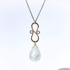 The Lunar Glow Necklace is a captivating piece that celebrates the ethereal beauty of moonlight. At its center, a large moonstone takes the spotlight, radiating its enchanting glow. Hanging from a delicate oxidized sterling silver chain is a hand-forged 14k gold filled swirling component, adding a touch of elegance and movement to the design. The intertwining swirls evoke a sense of cosmic energy and celestial allure. Embrace the mystical charm of our Lunar Glow Necklace, allowing it to become a Gold Hand Forged Moonstone Jewelry, Hand Forged Gold Moonstone Jewelry, Hand Forged Moonstone Gold Jewelry, Elegant Oxidized Moonstone Jewelry, Elegant Moonstone Jewelry With Oxidized Finish, Minimalist Hand Forged Moonstone Jewelry, Elegant Hand Forged Moonstone Jewelry, Hand Forged Teardrop Moonstone Jewelry, Delicate Hand Forged Jewelry