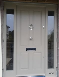 a white front door on a brick building