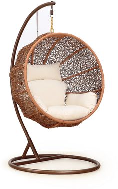 a brown hanging chair with white cushions