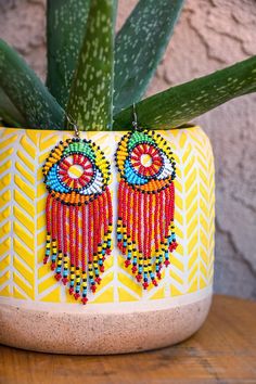 Zulu Beaded Tassel Earrings - Leone Culture Beaded Bohemian Chandelier Earrings For Party, Bohemian Beaded Chandelier Earrings For Party, Elegant Multicolor Beaded Hoop Earrings, Bohemian Beaded Earrings With Colorful Beads, Elegant Multicolor Hoop Earrings With Dangling Beads, Bohemian Beaded Chain Earrings For Party, Colorful Dangle Beaded Earrings For Party, Festival Beaded Chain Earrings, Unique Beaded Chandelier Earrings For Party