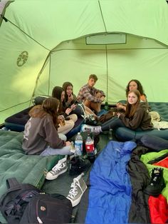 group of people sitting on an inflatable bed with backpacks and water bottles