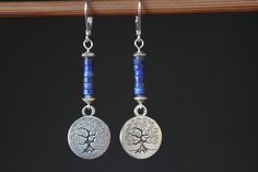 Inspired by nature, these blue dangle boho earrings are made with lapis lazuli stones, antique silver plated round charms featuring tree of life. They hang from sterling silver lever backs. These earrings are lightweight, comfortable and easy to wear everyday. They combine simplicity and charm to fit any casual or formal event. Color : Lapis Lazuli rondelle stones Finish : Sterling Silver lever back, Sterling Silver head pins, Antique Silver Round Tree Charms ( Lead and Nickel Free ). Length: 2- Nature-inspired Blue Dangle Earrings, Nickel-free Lapis Lazuli Dangle Earrings, Bohemian Lapis Lazuli Teardrop Jewelry, Blue Bohemian Sterling Silver Earrings, Blue Spiritual Dangle Earrings, Spiritual Blue Dangle Earrings, Bohemian Lapis Lazuli Earrings, Blue Spiritual Nickel-free Earrings, Blue Nature-inspired Drop Earrings