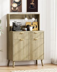 a wooden cabinet with two pictures above it and a coffee maker on the bottom shelf