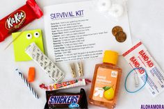 an assortment of candy, candies, and other items on a white surface with the text survival kit