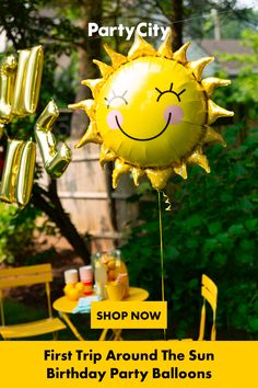 a yellow party balloon with a happy face on it and the words, shop now first trip around the sun birthday party balloons