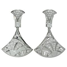 These fabulous Bvlgari earrings from the classic Diva's Dream collection features a mosaic fan design crafted in 18k white gold and set with 106 round brilliant E-F-G VVS1-VVS2 diamonds weighing an estimated 2.10 carats. Signed Bvlgari, numbered, with Italian hallmarks. Made in Italy circa 2010s. Measurements: 0.82" (21mm) width, 1.57" (40mm) length. Art Deco White Gold Diamond Earrings With Brilliant Cut, Luxury Platinum Diamond Earrings For Evening, Luxury Platinum Diamond Earrings With Brilliant Cut, Art Deco Silver Diamond Earrings In Platinum, Silver Art Deco Platinum Diamond Earrings, Art Deco White Gold Diamond Earrings, Bvlgari Earrings, Bvlgari Jewelry, Fan Design