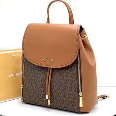 Brand New With Tag Michael Kors Medium Phoebe Flap Drawstring Backpack Pvc Leather Color: Vanilla Gold Toned Hardware Mk Brown Signature Color Michael Kors Logo On Front 2 Side Zip Pocket At Front Flap Snap Top Closure Custom Fabric Lining 2 Slip In Pocket 1 Zipper Pocket 11.75" (L) 13"(H) 5.25"(D) 3.25" Top Handle, Adjustable Backpack Straps Luxury Michael Kors Backpack With Detachable Strap, Michael Kors Backpack With Detachable Strap, Luxury Backpack For Errands, Leather Backpack With Branded Hardware For Travel, Elegant Backpack With Branded Hardware, Designer Leather Backpack For Errands, Michael Kors Rhea Backpack, Michael Kors Mini Backpack, Mini Leather Backpack