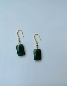 A pair of elegant rectangle-shaped dark green jade cube earrings with 14k gold ear wire. They are made from high-quality real Chinese jade and 925 sterling silver plated with 14k gold. Simple and minimalistic design works great for all sorts of occasions: dating, daily wear, home or office, you name it. Perfect as a gift for your loved ones or yourself. Highlights: ♥ High-quality materials Hand-made with quality dark green jade, paired with 925 sterling silver plated with 14k gold. Ensure long last wear and they are friendly for sensitive skin. ♥ Simple and minimalistic design Great for all sorts of occasions and perfect for gifting  ♥ Measurements Each drop is measured 1.5cm diameter and 2.5cm long. ♥ 100% Satisfaction Guarantee Gift-worthy packaging included! Please include a message if Cheap Green Minimalist Jewelry, Cheap Green Danglers Perfect As Gifts, Cheap Bohemian Green Earrings, Handmade Jade Earrings, Affordable Handmade Jade Earrings, Affordable Jade Bead Earrings, Cheap Everyday Green Earrings, Elegant Dark Green Jade Jewelry, Elegant Green Rectangular Earrings