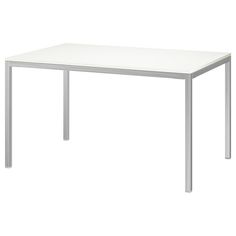 a white table sitting on top of a white floor