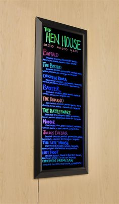 the menu for the hen house restaurant is displayed in a black frame on a wooden wall