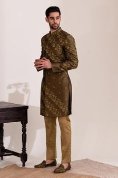 Olive green long sleeves sherwani with all over flora vine garden embroidery with sequin highlights. Paired with a beige straight pant.
Components: 2
Pattern: Embroidered
Type Of Work: Flora Vine Garden
Neckline: Mandarin Collar
Sleeve Type: Long
Fabric: Raw Silk, Cotton
Color: Green
Other Details: 
Approx weight: 3kgs
Poly lining
Occasion: Mehendi and Puja, Sangeet - Aza Fashions Vine Garden, Garden Embroidery, Embroidered Silk, Raw Silk, Straight Pants, Mandarin Collar, Aza Fashion, Sleeve Type, Olive Green