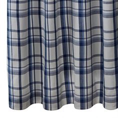 a blue and white checkered curtain hanging on a rodo - end window sill