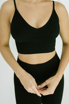 STYLE + FIT NOTES: The Dash Crop Top + Biker Short Set is next level! Ultra stretchy material that will have you looking + feeling like a million bucks! Cropped top + high waisted biker shorts with a ribbed material - we know this set will be your new go-to. Looks perfect paired with sneakers for a sporty feel or elevated with a chunky sandal + a blazer. Grab in your true size + prepare to wear on repeat! Versatile Black Crop Top With Built-in Bra, Black Seamless High-waist Activewear, Black Cropped Activewear With Built-in Bra, Black Seamless V-neck Sports Bra, Fitted Black V-neck Sports Bra, Black Seamless Crop Top For Loungewear, Chic Black Crop Top With Seamless Construction, High Waist Stretch Black Crop Top, Seamless Black Crop Top For Loungewear