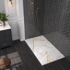 a bathroom with grey and white tile, wood flooring and a walk in shower