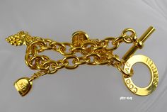 "This gorgeous Estate bracelet features brand-name cognac bottles by grapes vine / grapes clusters. The clasp is marked \"Cognac Frapini\". This estate jewelry is crafted of shining high polish 18K gold plated. Metal weight: 2.2 oz. Bracelet dimensions: 1 1/4\" wide x 8\" long with the toggle clasp. It is vintage item in very good condition. Please see enlarged pictures for a detailed view. All returns must be postmarked within 7 days from the date you received the item. All sales are final afte Gold Bracelets With Logo Charm For Formal Occasions, Formal Gold Bracelets With Logo Charm, Vintage Gold Jewelry Aaa Quality, Luxury Charm Bracelet For Anniversary, Luxury Gold Charm Bracelet For Anniversary, Charms Bracelet, Gold Charm Bracelet, Gold Plated Bracelets, Bracelet Gold