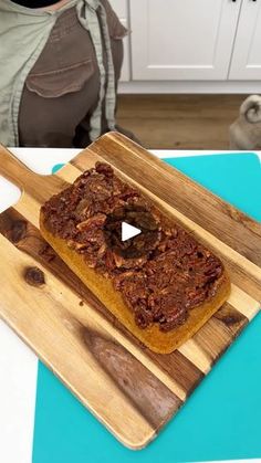 a wooden cutting board topped with food on top of a counter