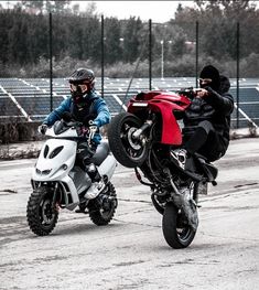 two motorcyclists are riding their bikes in the parking lot