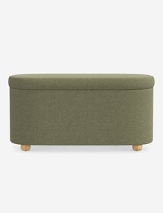 an upholstered bench with wooden legs and a green fabric cover on the back