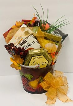 a bucket filled with lots of different types of food and candys on top of a white table