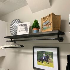 there is a shelf with pictures and other items on it