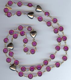 "This rarely seen vintage silver tone puffy hearts and bright hot pink bezel set crystal necklace has the Swarovski swan hang tag. Measures approximately 30-1/2\" in length. It is set in gold tone. The bezel set crystals measure 3/8\". Very nice condition." Vintage Pink Necklaces For Valentine's Day, Vintage Pink Necklace For Valentine's Day, Vintage Jewelry For Valentine's Day Party, Vintage Pink Heart Necklaces, Vintage Pink Jeweled Necklace, Vintage Pink Necklace For Anniversary, Vintage Pink Jewelry With Heart Beads, Vintage Pink Necklace With 17 Jewels, Swarovski Swan