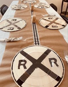 the table is set with paper plates and napkins that have railroad crossing symbols on them