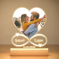 a heart shaped photo frame with an image of a couple holding each other