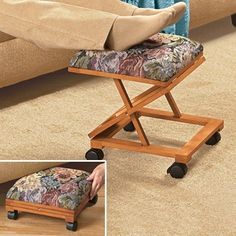 the foot stool has wheels on it and is placed in front of a couch with pillows