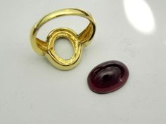 Gemstone: Garnet Treatments: Untreated Specifications: 14x10mm, approx. 7.60 carats Color: As shown Clarity: Eye clean, no visible inclusions Cut: Oval Cabochon Please note that the center stone is not set in the ring and will be once the ring is sold. This allows us to safely reset the stone once it has been sized. The ring weighs 6 grams and is solid 14K yellow gold. This ring is also available in 14K white gold and 14K rose gold. There is no additional charge for this service. The ring is als Gold Oval Ruby Ring For Formal Occasions, Formal Gold Pear-shaped Ruby Ring, 14k Gold Polished Oval Cabochon Ruby Ring, Polished Yellow Gold Garnet Jewelry, Oval Red Garnet Jewelry, Yellow Gold Garnet Ring With Polished Finish, Luxury Garnet Oval Cabochon Rings, Gold Infinity Ring, Infinity Ring