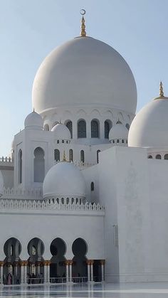 a large white building with many domes on it