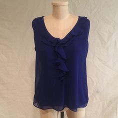 This Sleeveless Top Is Perfect For A Night Out Or A Day At The Office. With A Ruffled Front This Can Pair Well With A Simple Cardigan Or Fitted Blazer. Blue Tank Vest Blouse, Blue Ruffled Cami Tank Top, Chic Blue Tank Vest, Blue Ruffled Tank Top, Blue Ruffled Sleeveless Camisole, Simple Cardigan, Day At The Office, Fitted Blazer, The Office