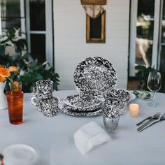 a white table topped with plates and silverware