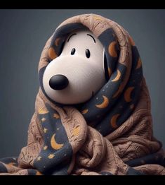 a stuffed animal wrapped in a blanket