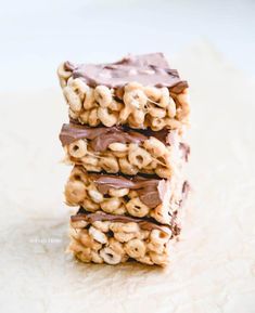 there are three pieces of food stacked on top of each other with chocolate and cereal in the middle