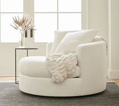 a white chair with a blanket on it