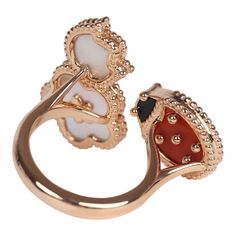 This Van Cleef & Arpels Lucky Spring Between the Finger Ring in Carnelian, Mother of Pearl and Onyx with 18K rose gold hardware, featuring a Carnelian and Onyx ladybug motif and one mother of pearl rose and one classic mother-of-pearl clover motif. Origin: FranceCondition: New and never wornAccompanied by: VCA gift box, VCA green jewelry box and authenticity card Measurements: ring size: 50 | US size: 5 1/4 Luxury White Gold Enamel Oval Ring, Luxury Formal Enamel Ring With Gemstone, Formal Luxury Enamel Ring With Gemstone, Luxury Multi-stone Rose Gold Ring, Elegant Yellow Gold Enamel Ring, Luxury Polished Open Enamel Ring, Luxury Multi-stone Rose Gold Jewelry, Luxury Rose Gold Multi-stone Jewelry, Luxury Enamel Ring