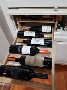 several bottles of wine are sitting in a drawer