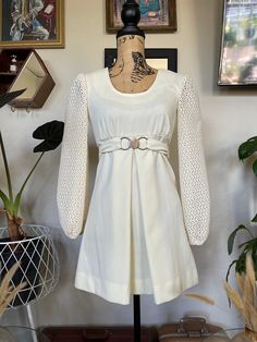 "Absolutely stunning, one of a kind 1960s vintage mod mini dress! Color can best be described as an off-white or cream. Scoop neckline. A-line to flatter your figure. Gorgeous bishop long sleeves made with a crochet/lace-like fabric. Original faux belt intact with a silver buckle closure (see picture). Front center pleat on the skirt. Insanely adorable. Perfect for a formal event or even as a wedding dress for your picture perfect vintage inspired wedding! In excellent vintage condition! Measure White Vintage Mini Dress, Mini Skirt Wedding Dress, Short White Vintage Dress, 1960s Party Dress, Cream A-line Mini Dress For Fall, Off White Long Sleeve Mini Dress For Fall, Vintage Fitted Long Sleeve Mini Dress, Off White Long Sleeve Mini Dress, Vintage Long Sleeve Mini Dress For Fall