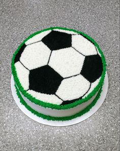 a soccer ball cake with green and white frosting