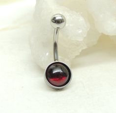 Garnet Belly Ring Show off your beautiful belly! Simple non dangle style belly ring features a natural garnet gemstone cabochon. The true beauty of these stones is hard to capture in photographs and is much more beautiful in person. Belly button ring measures 1 inches long total length. Barbell is 14g surgical steel with a 10mm wearable bar length. Top ball measures 5mm, bottom measure 8mm. All jewelry comes in a gift box for safe keeping or ready for gift giving. For Belly Button Rings: https:/ Top Belly Button Piercing, Belly Ring Piercing, Navel Piercing Jewelry, Bellybutton Piercings, Belly Button Piercing Jewelry, Belly Piercing Ring, Navel Jewelry, Tooth Gem, Belly Jewelry